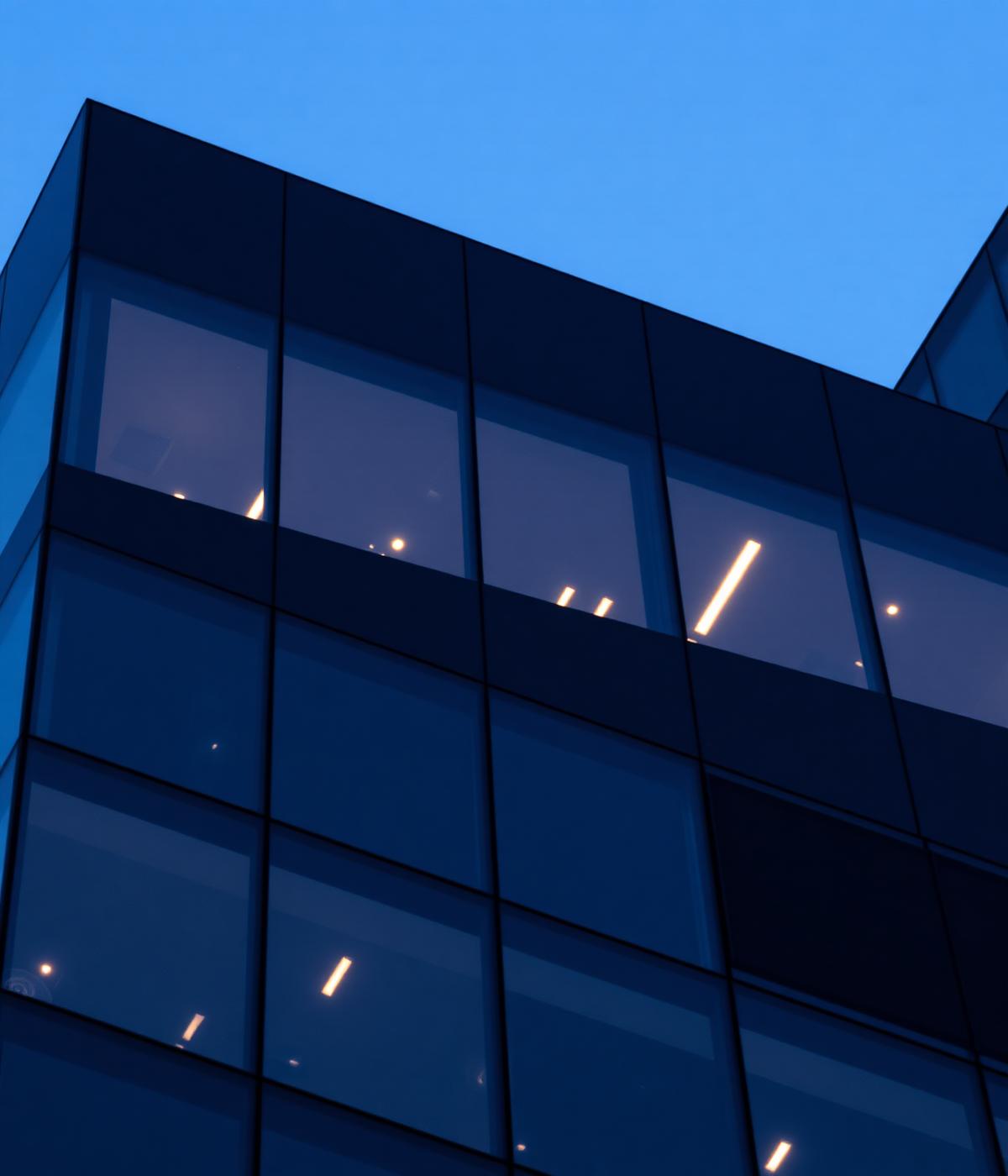Modern glass tower at dusk